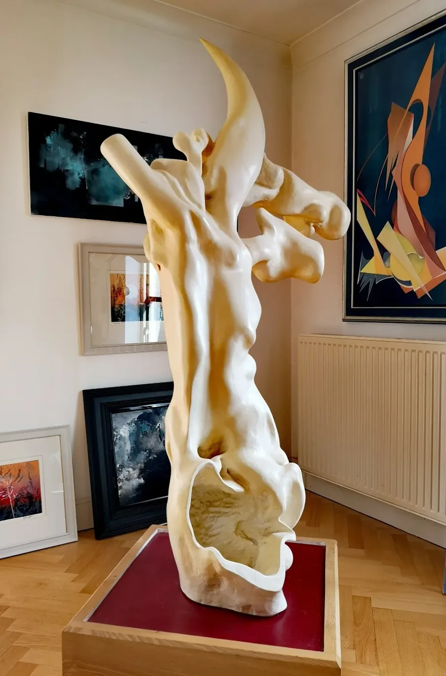 The White Hart, a carved wood sculpture by Bruce Thomson, a tall pale form rising to a single curved crest