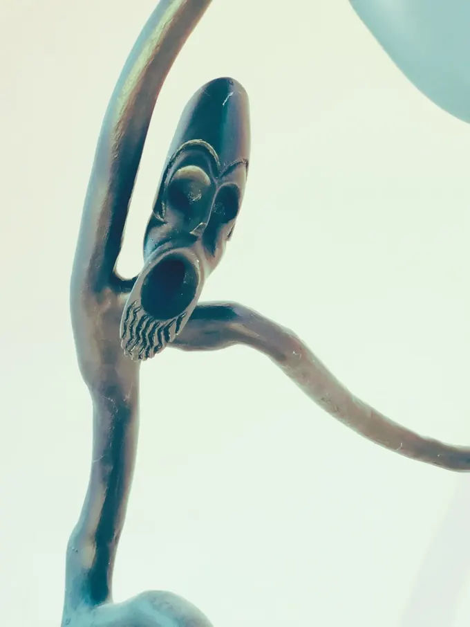 Warrior (detail), a close view by Bruce Thomson of a carved head cut into a narrow mask with a bearded jaw