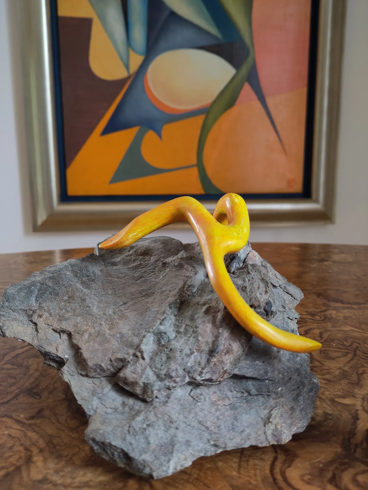 Starfish on a Rock, a sculpture by Bruce Thomson of a carved yellow starfish laid across a grey block of stone