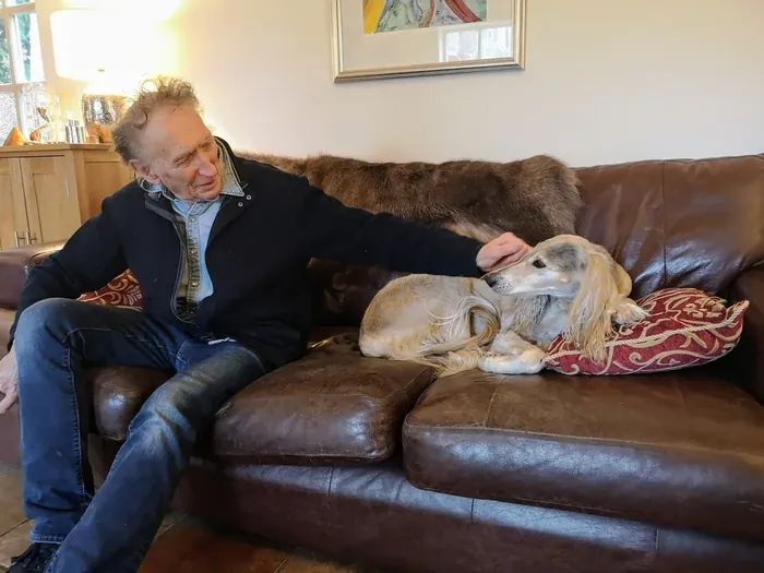 The artist Bruce Thomson at home with his saluki